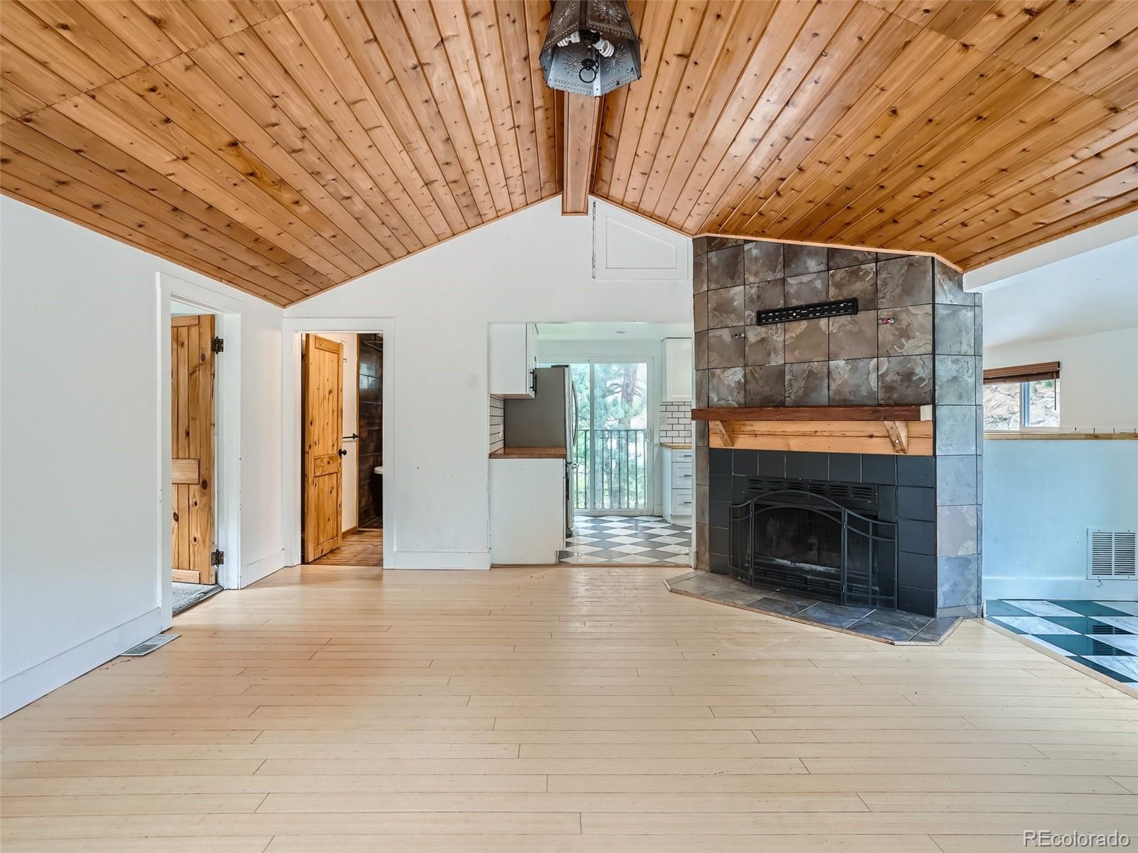 11799 Ranch Elsie Road Golden, CO 80403 - Photo 8 of 28 a view of an empty room with a fireplace