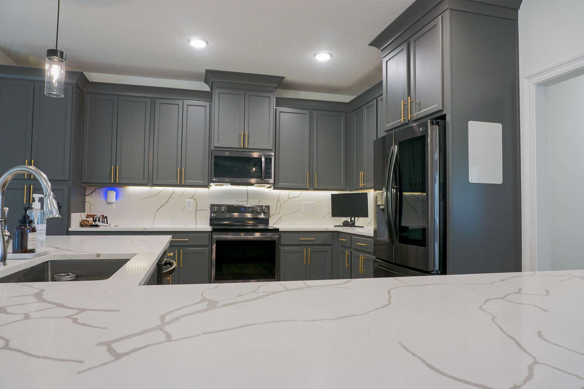 5464 Jenee Court Crestview, FL 32539 - Photo 13 of 63 a kitchen with granite countertop a refrigerator and a sink