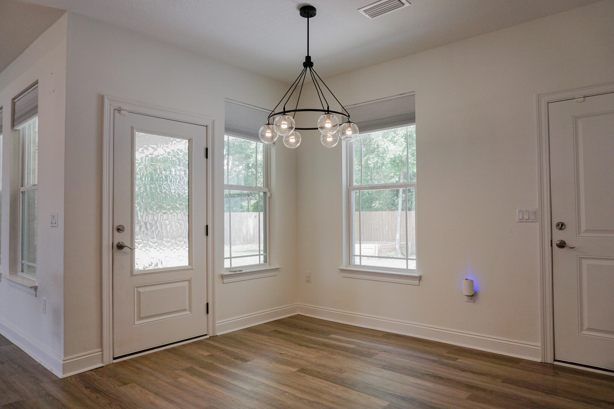 5464 Jenee Court Crestview, FL 32539 - Photo 20 of 63 a view of an empty room with wooden floor and a window