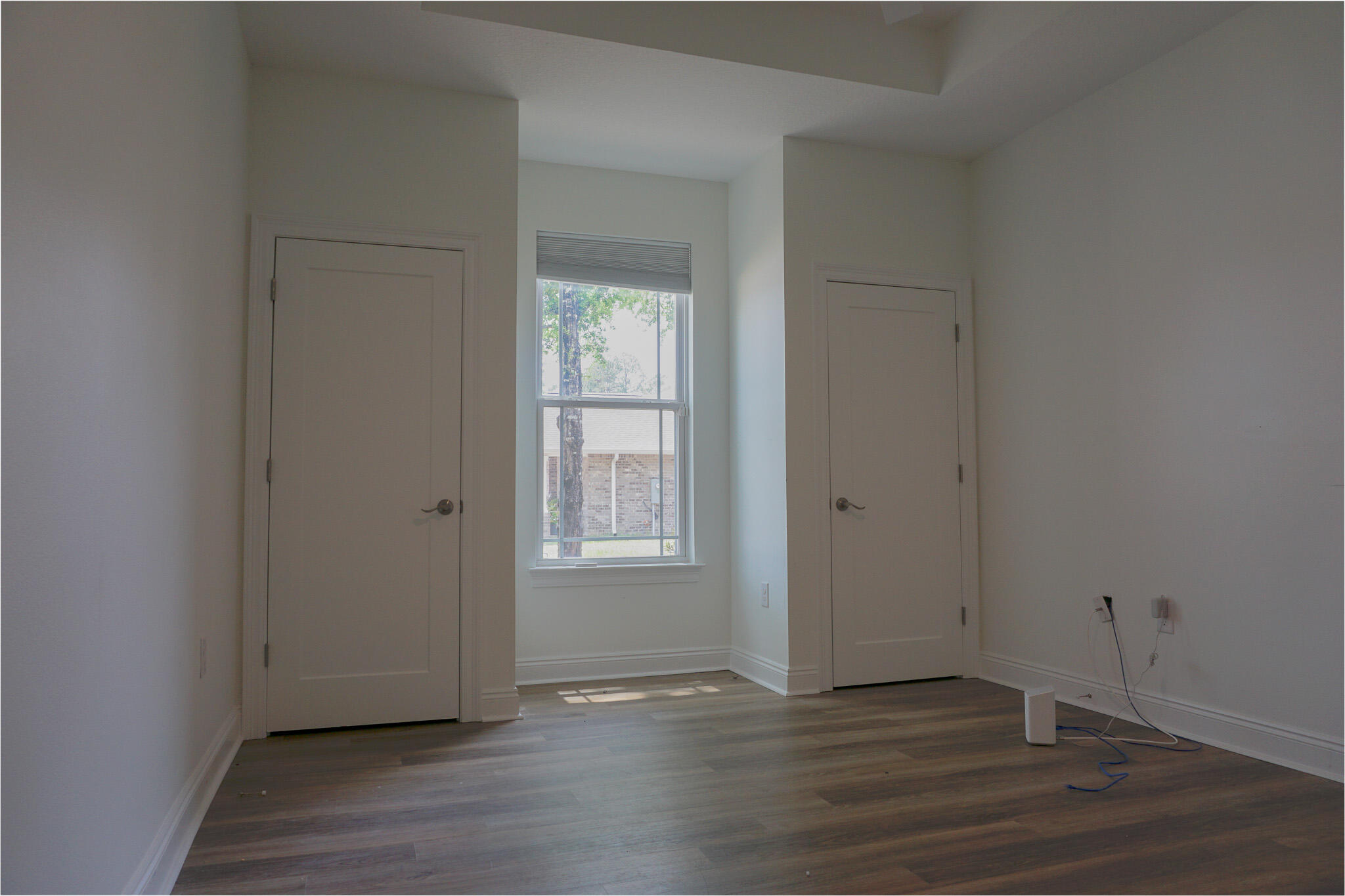 5464 Jenee Court Crestview, FL 32539 - Photo 29 of 63 an empty room with wooden floor and windows