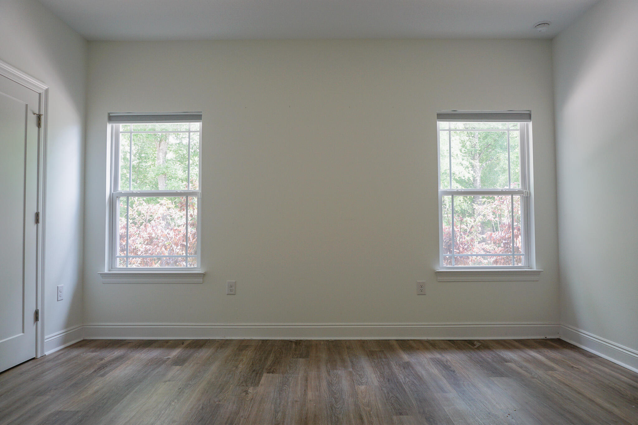 5464 Jenee Court Crestview, FL 32539 - Photo 38 of 63 a view of an empty room with wooden floor and a window