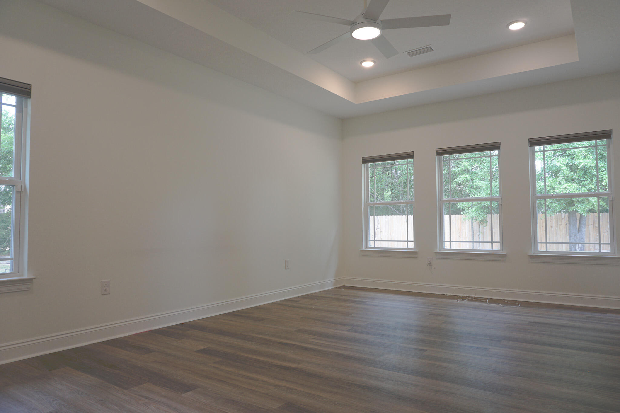 5464 Jenee Court Crestview, FL 32539 - Photo 41 of 63 an empty room with wooden floor and windows