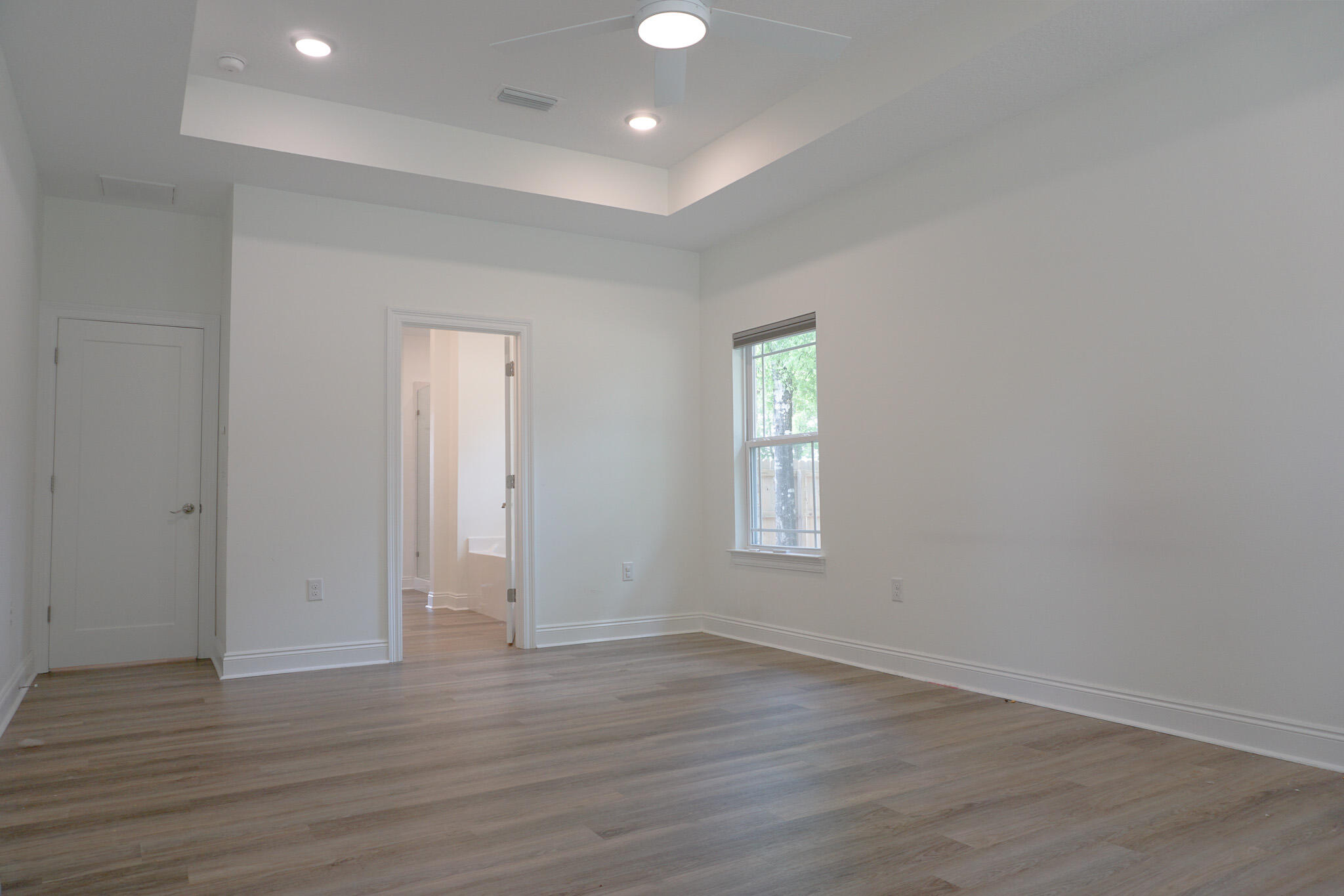 5464 Jenee Court Crestview, FL 32539 - Photo 42 of 63 an empty room with wooden floor and windows