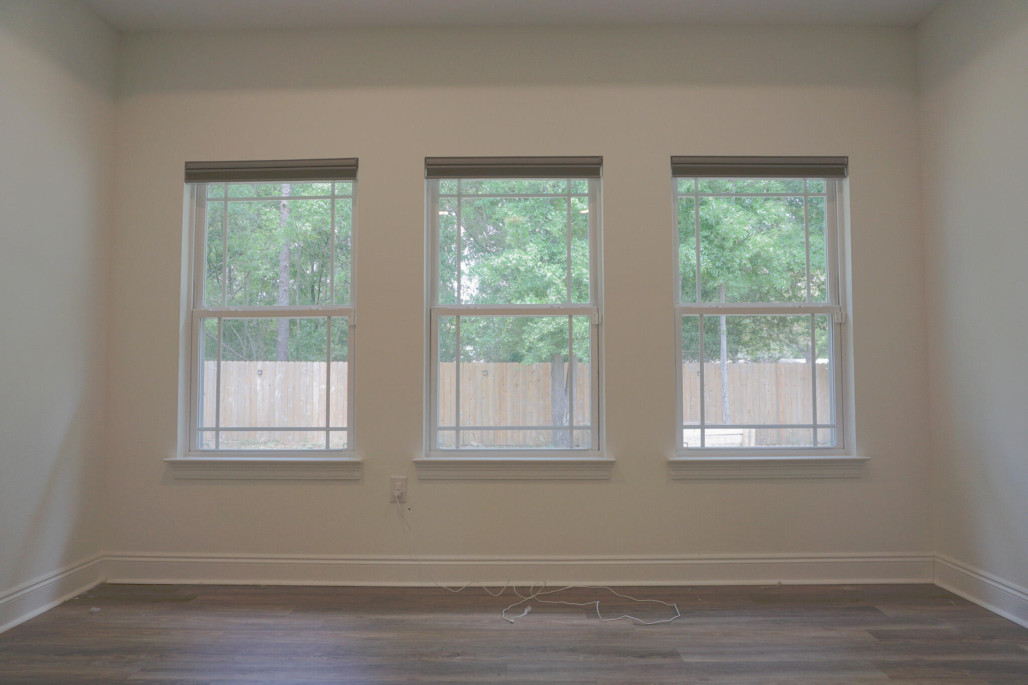 5464 Jenee Court Crestview, FL 32539 - Photo 43 of 63 a view of an empty room with wooden floor and windows