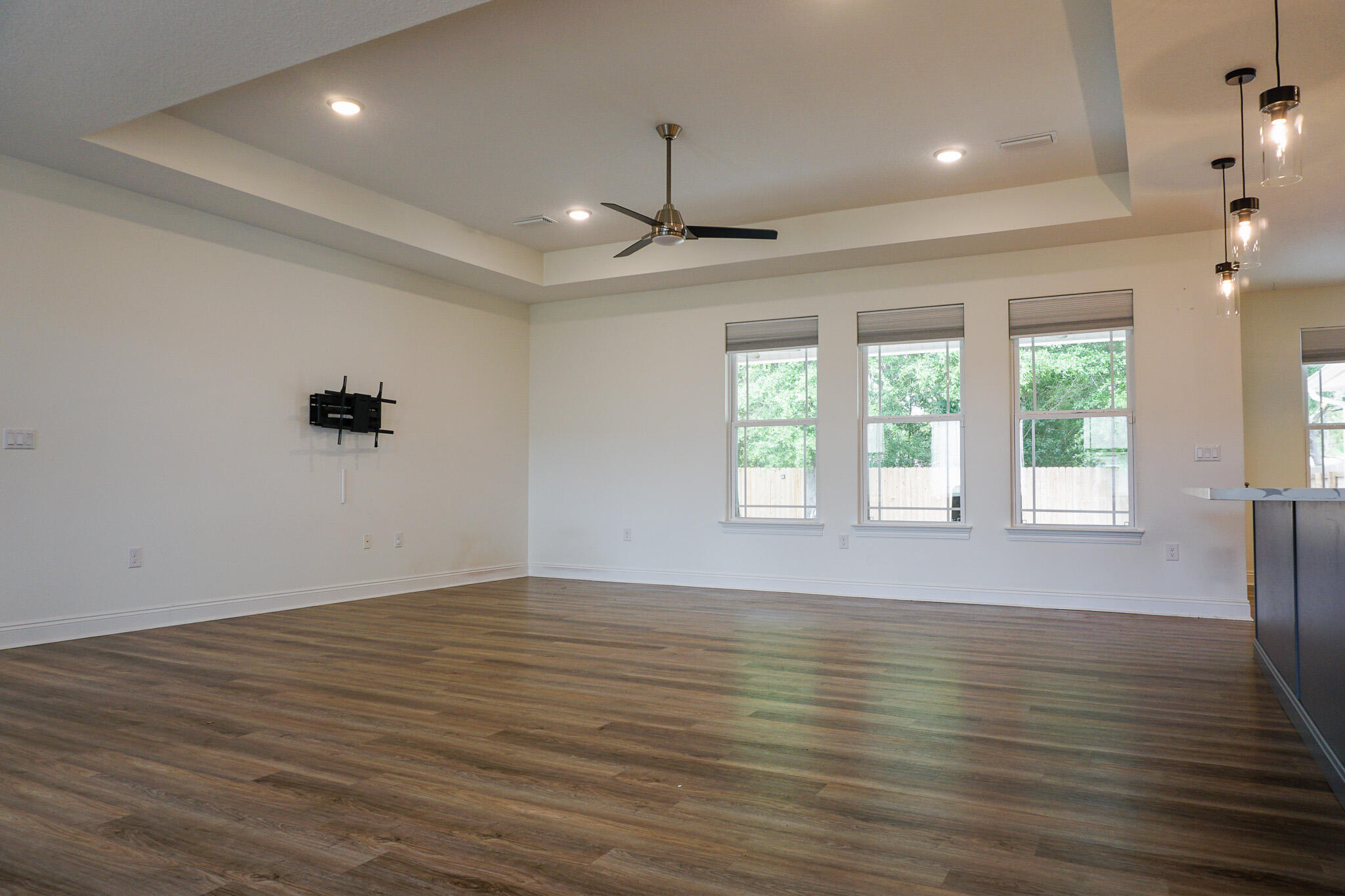 5464 Jenee Court Crestview, FL 32539 - Photo 8 of 63 an empty room with wooden floor chandelier and windows