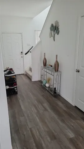 a view of a livingroom with furniture and wooden floor