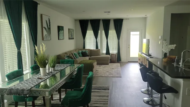 a living room with furniture and large windows