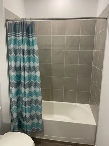 a bathroom with a bathtub and toilet