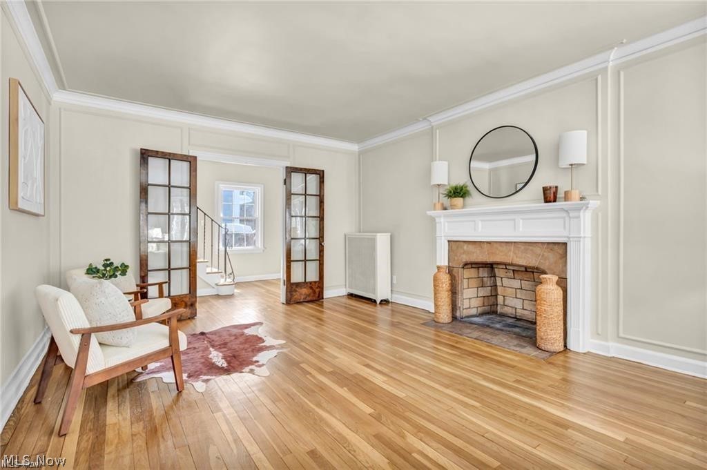 3145 Huntington Road Shaker Heights, OH 44120 - Photo 5 of 28 Hardwood flooring throughout featuring a decorative fireplace with a stone surround and brick firebox