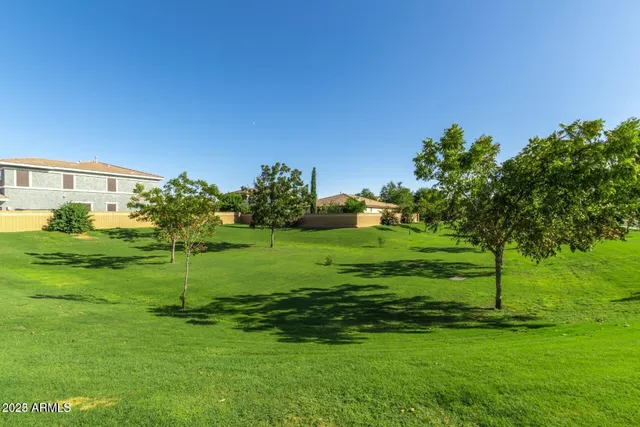 a backyard of a house with lots of green space and outdoor seating