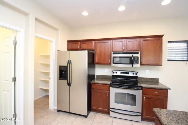 a kitchen with stainless steel appliances a refrigerator stove and microwave