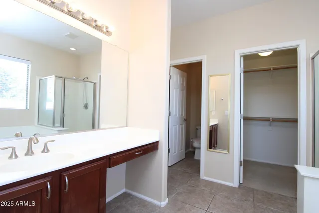 a bathroom with a sink a mirror and a shower