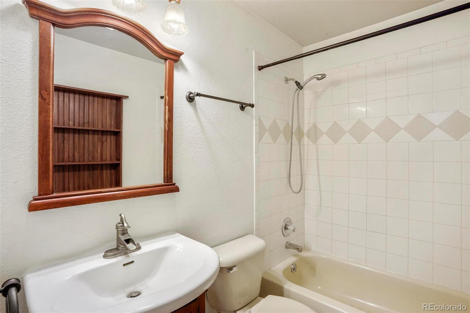 13519 Elsie Road Conifer, CO 80433 - Photo 12 of 31 a bathroom with a sink a toilet and shower