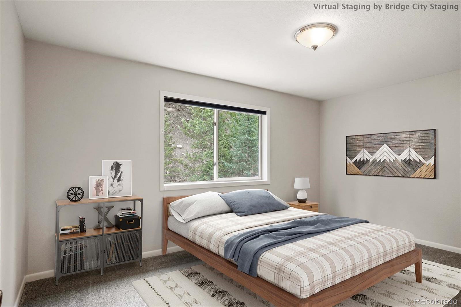 13519 Elsie Road Conifer, CO 80433 - Photo 13 of 31 a bedroom with a bed and a painting on the wall