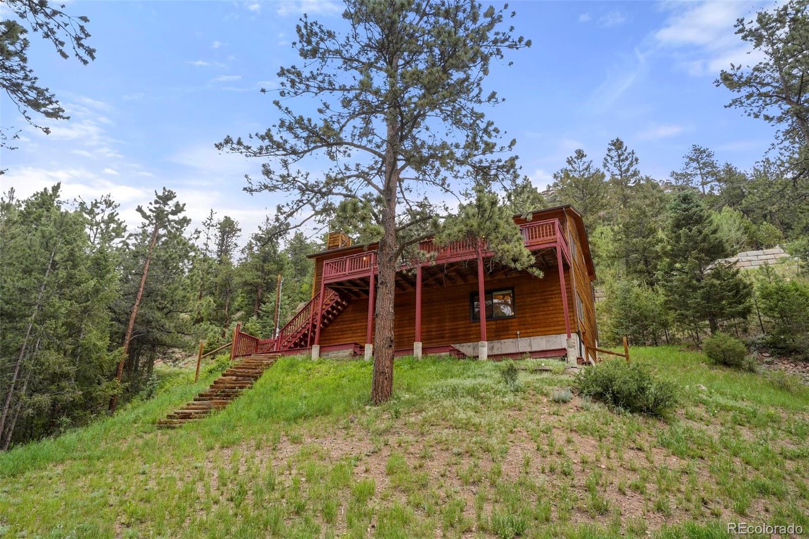 13519 Elsie Road Conifer, CO 80433 - Photo 22 of 31 a view of a house with a yard and tree s