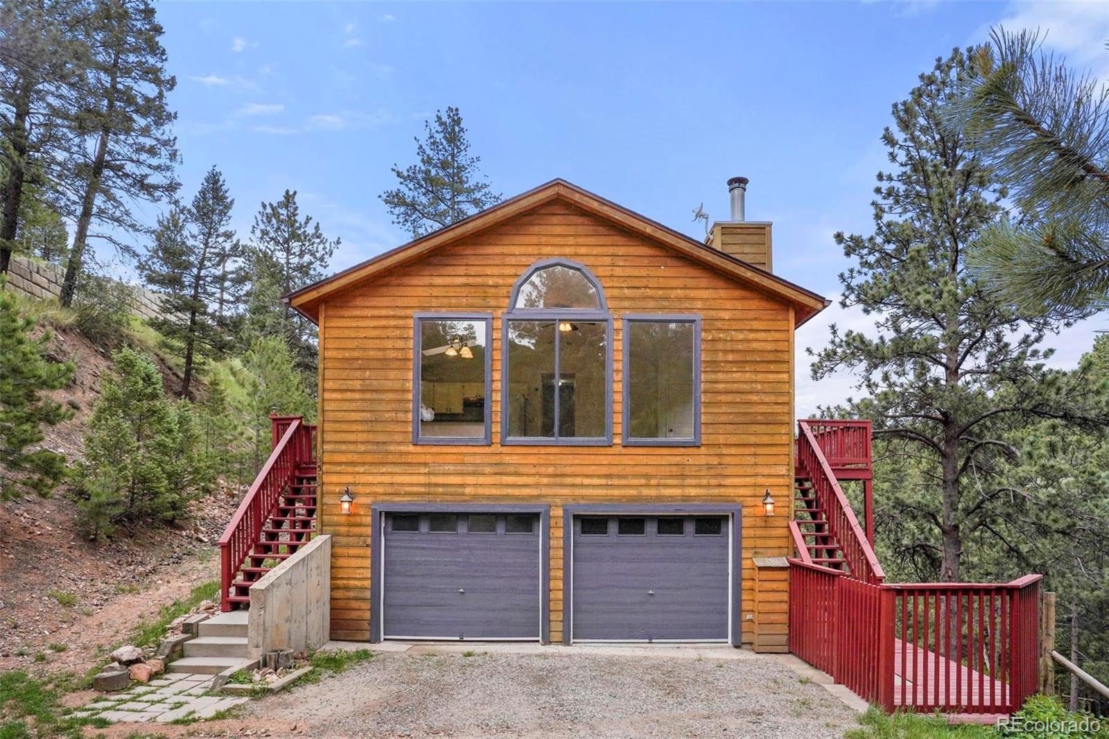 13519 Elsie Road Conifer, CO 80433 - Photo 3 of 31 a front view of a house with a yard