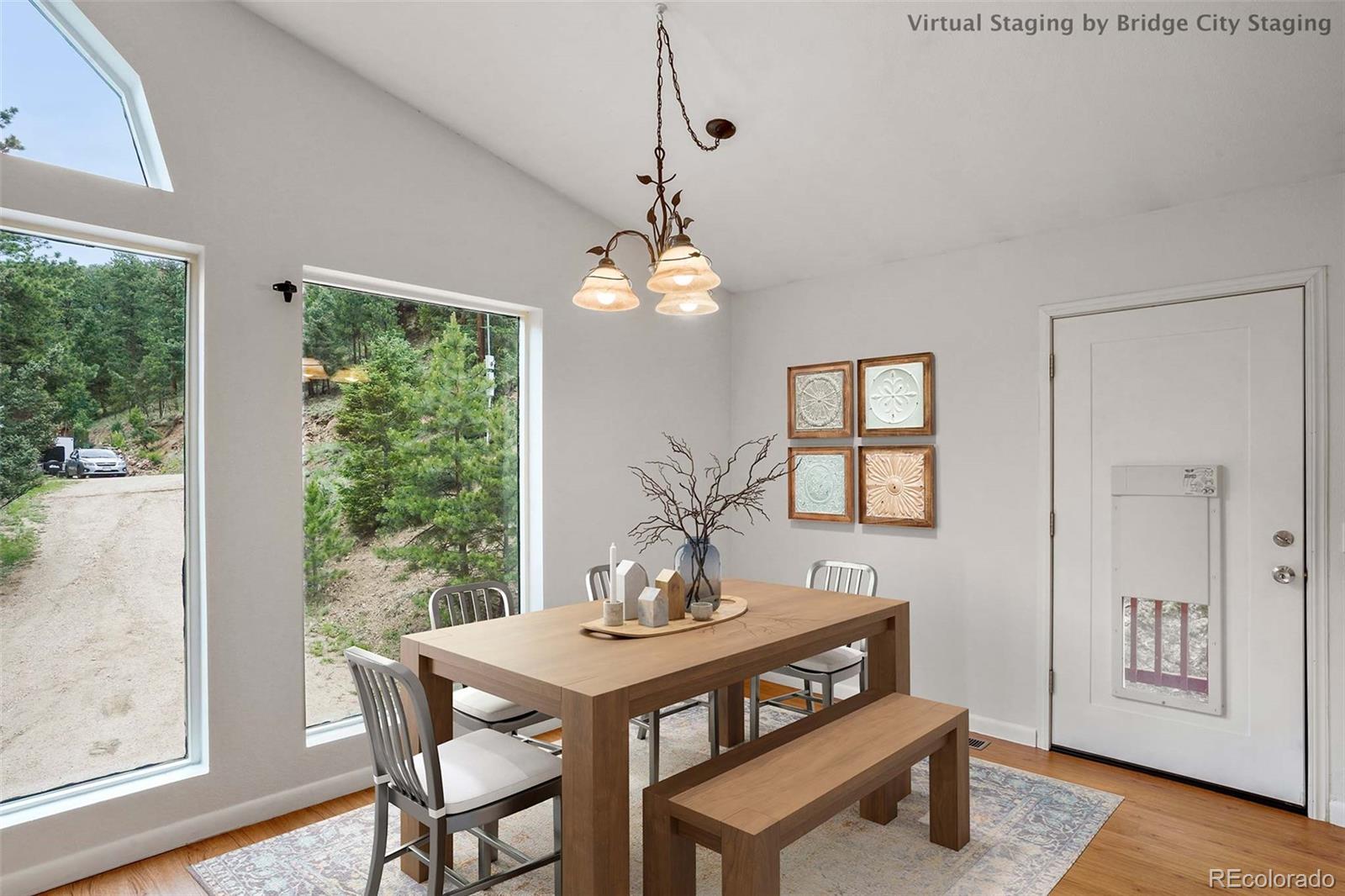 13519 Elsie Road Conifer, CO 80433 - Photo 4 of 31 a view of a dining room with furniture window and wooden floor