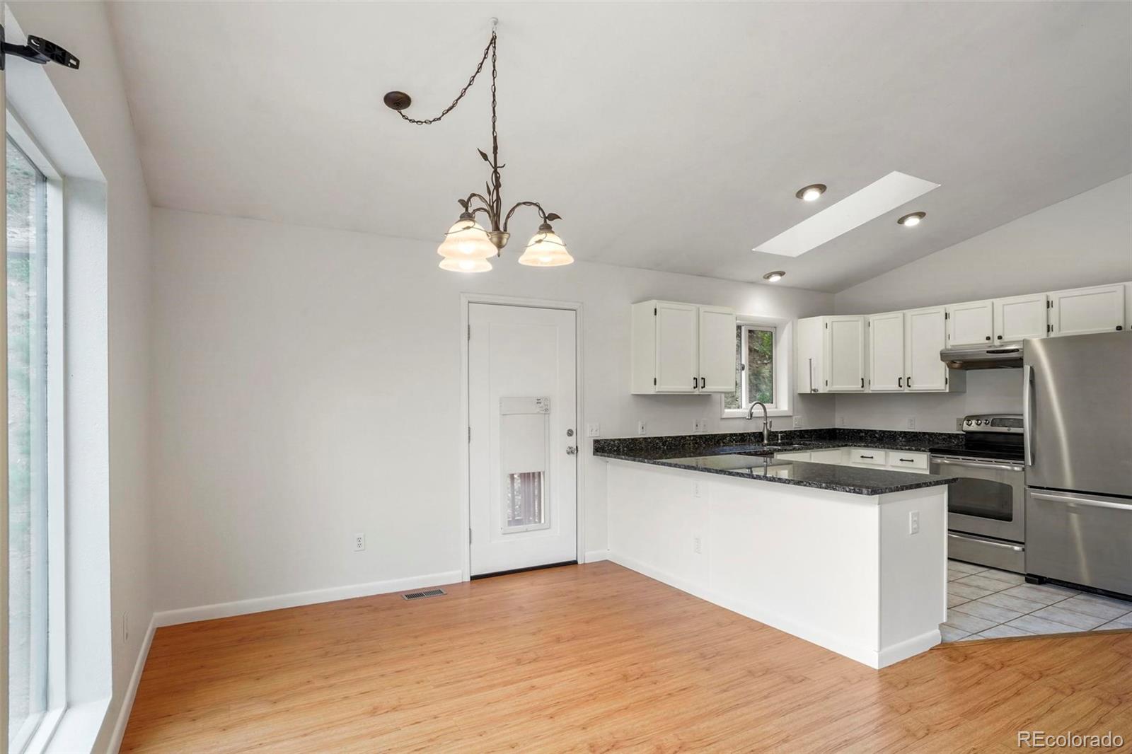 13519 Elsie Road Conifer, CO 80433 - Photo 5 of 31 a kitchen with stainless steel appliances granite countertop a sink a stove and refrigerator