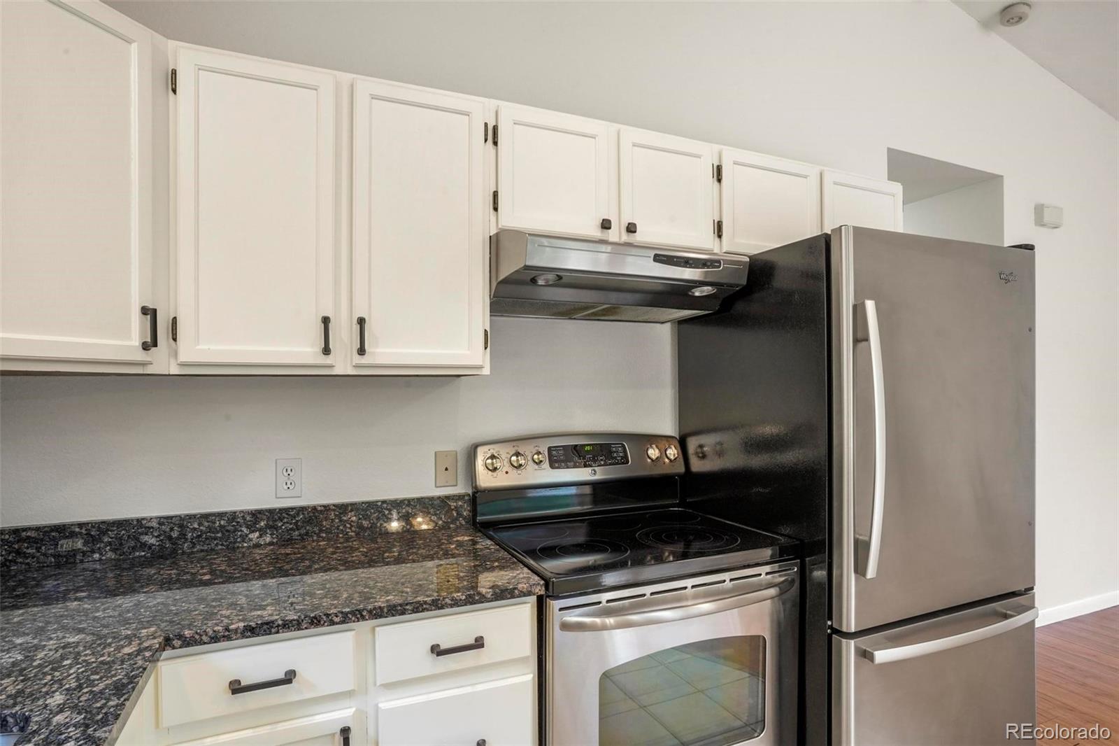 13519 Elsie Road Conifer, CO 80433 - Photo 9 of 31 a kitchen with granite countertop white cabinets and stainless steel appliances
