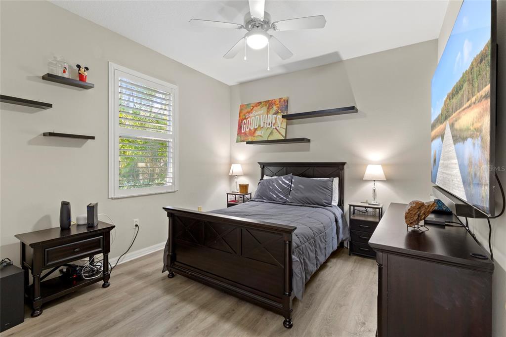 11011 Water Lily Way Lakewood Ranch, FL 34202 - Photo 12 of 24 a bedroom with a bed and a chandelier