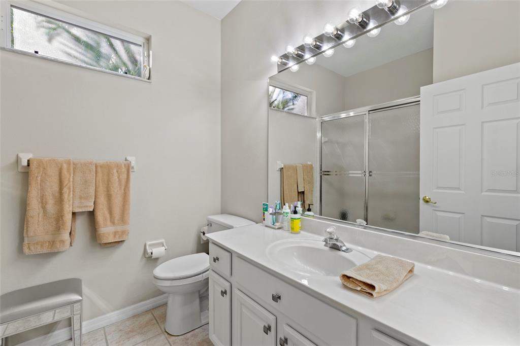 11011 Water Lily Way Lakewood Ranch, FL 34202 - Photo 13 of 24 a bathroom with a sink vanity granite toilet and a mirror