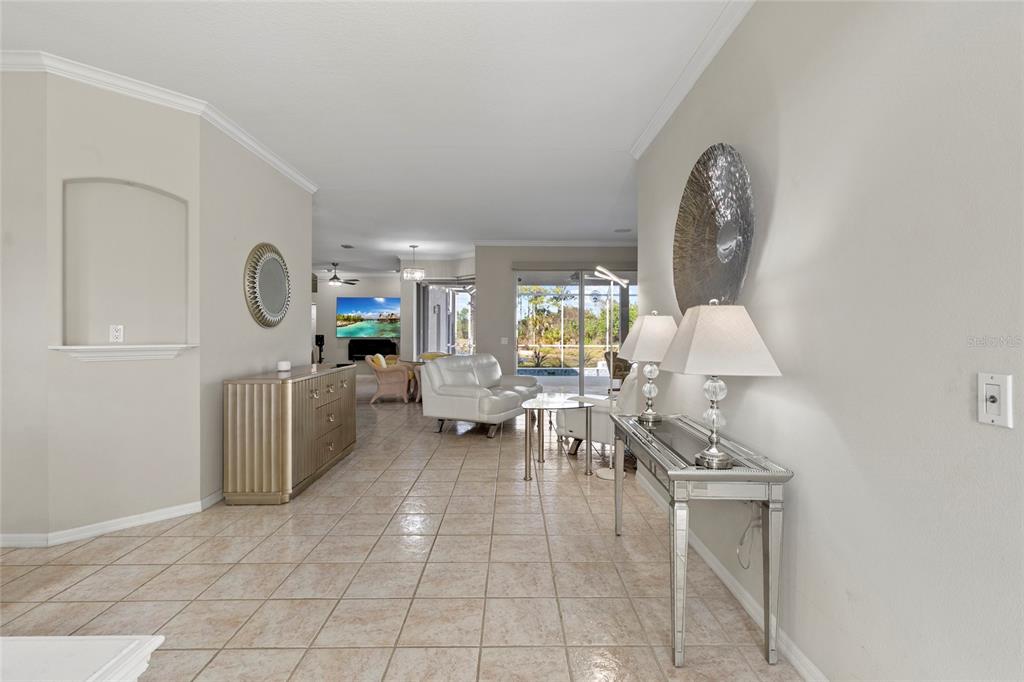 11011 Water Lily Way Lakewood Ranch, FL 34202 - Photo 2 of 24 a living room with furniture a window and a clock