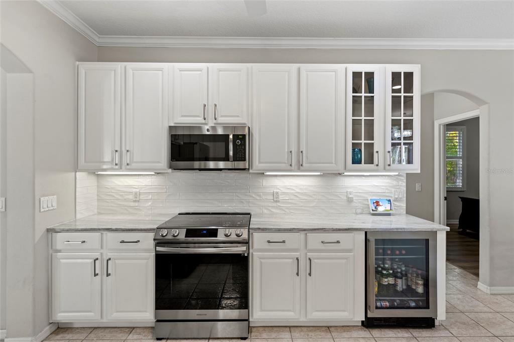 11011 Water Lily Way Lakewood Ranch, FL 34202 - Photo 4 of 24 a kitchen with stainless steel appliances granite countertop a stove and a microwave