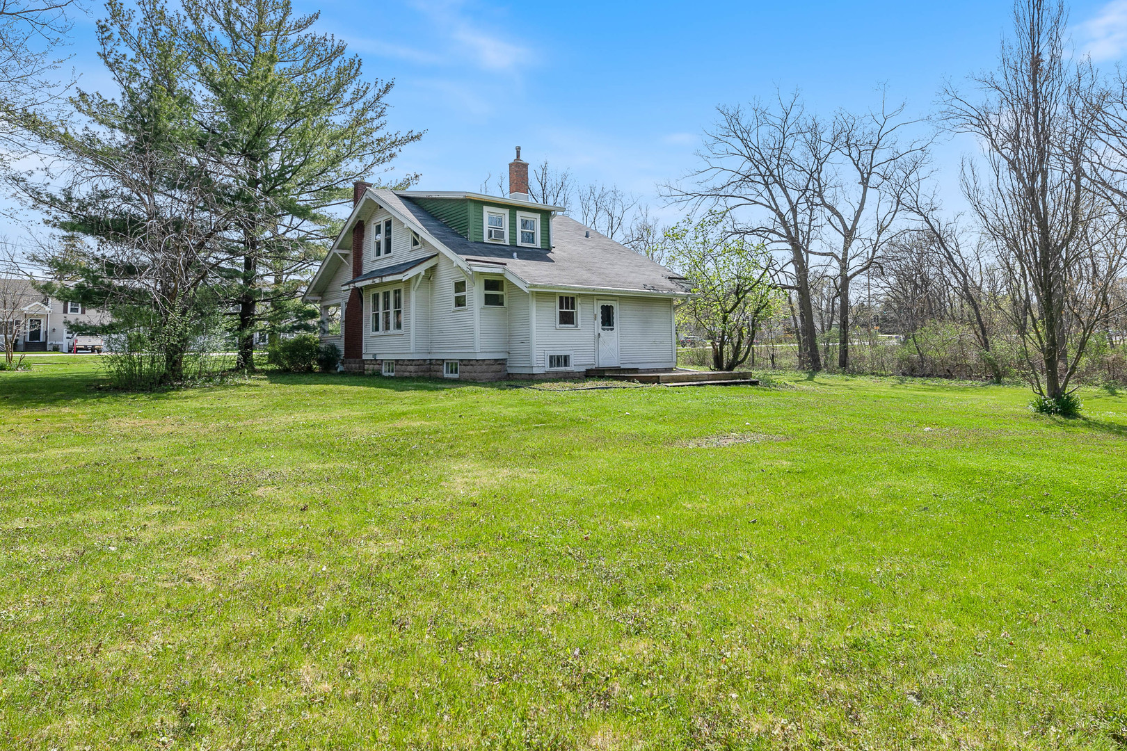300 Geneva Road Glen Ellyn, IL 60137 - Photo 3 of 3 a big white house with a big yard and large trees
