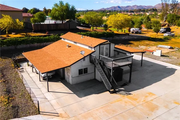 a roof deck with table and chairs