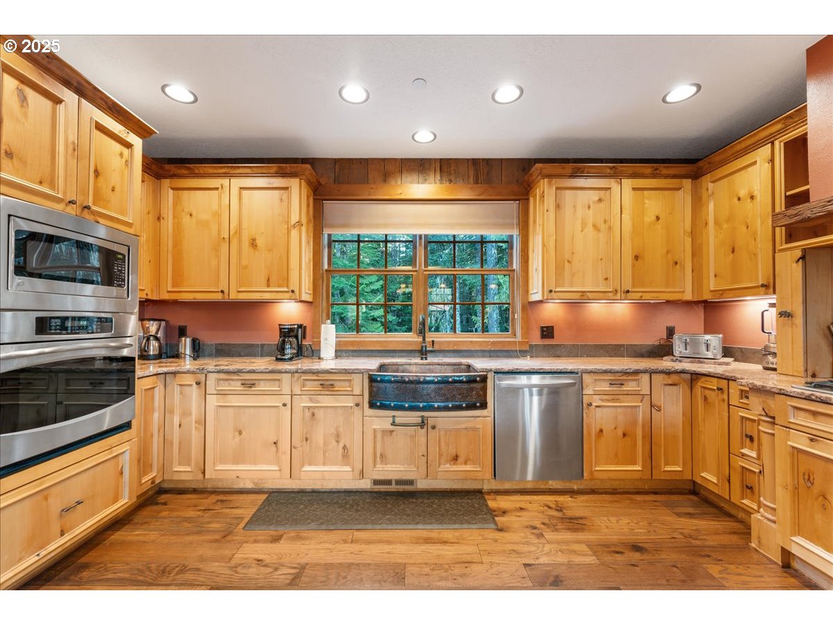 30930 Tyrolean Lane Government Camp, OR 97028 - Photo 16 of 42 a kitchen with stainless steel appliances granite countertop a stove a sink and a microwave