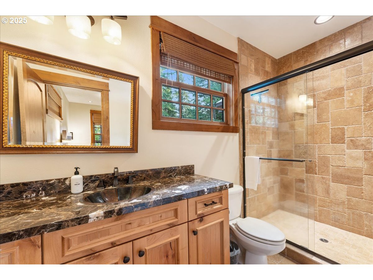 30930 Tyrolean Lane Government Camp, OR 97028 - Photo 21 of 42 a bathroom with a granite countertop sink toilet a mirror and shower