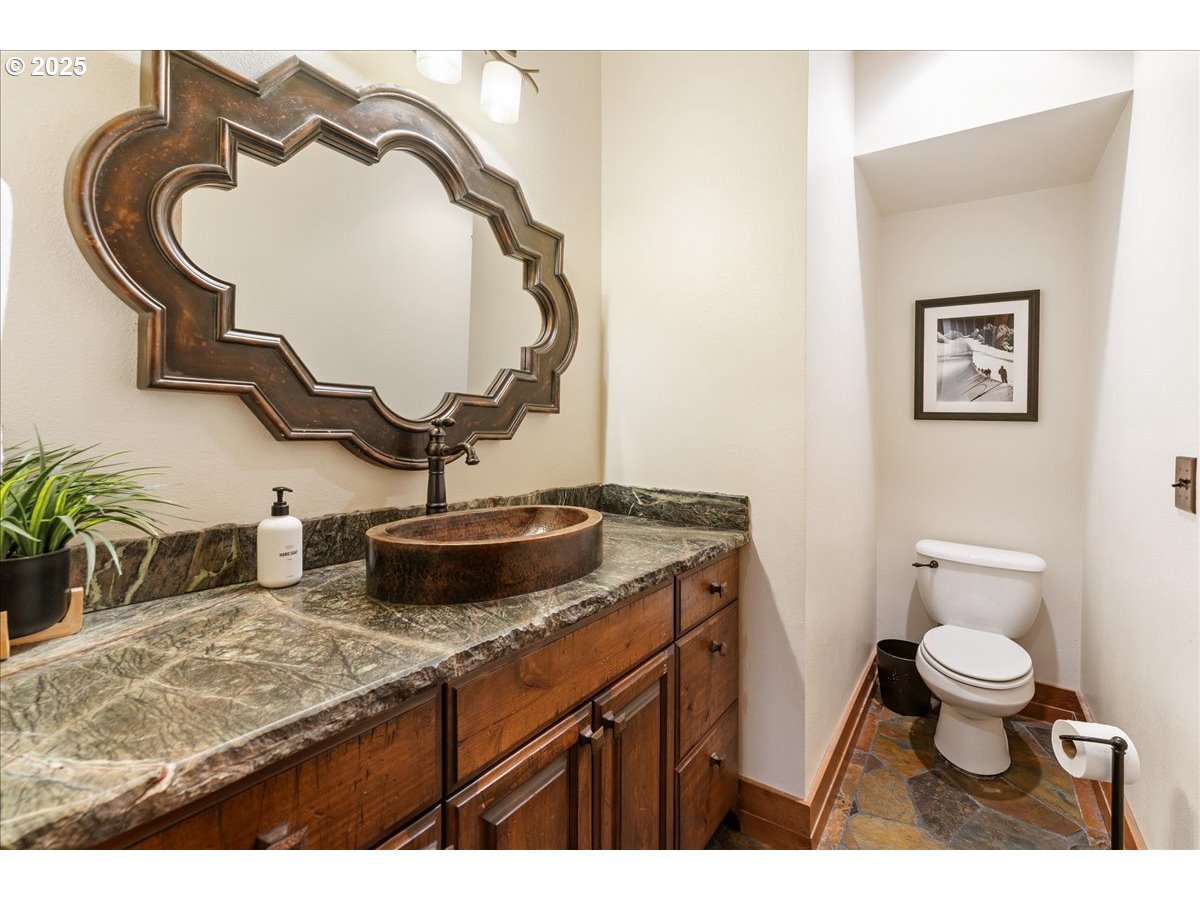 30930 Tyrolean Lane Government Camp, OR 97028 - Photo 23 of 42 a bathroom with a granite countertop toilet sink and mirror