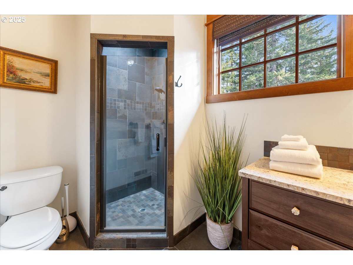 30930 Tyrolean Lane Government Camp, OR 97028 - Photo 39 of 42 a bathroom with a toilet a sink and glass window