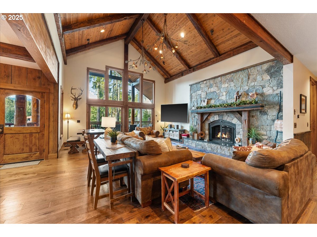 30930 Tyrolean Lane Government Camp, OR 97028 - Photo 7 of 42 a living room with furniture a fireplace and a large window