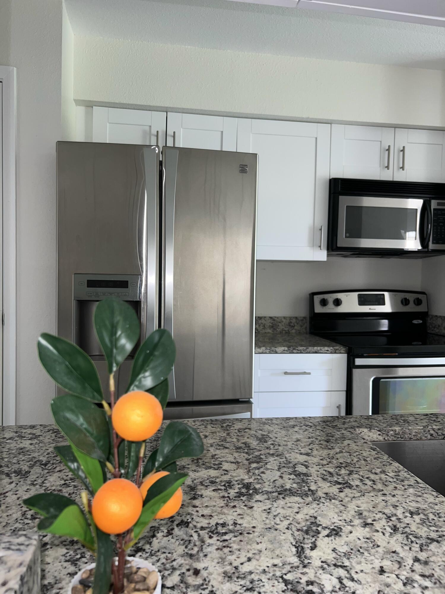 a kitchen with a stove a refrigerator and a fireplace