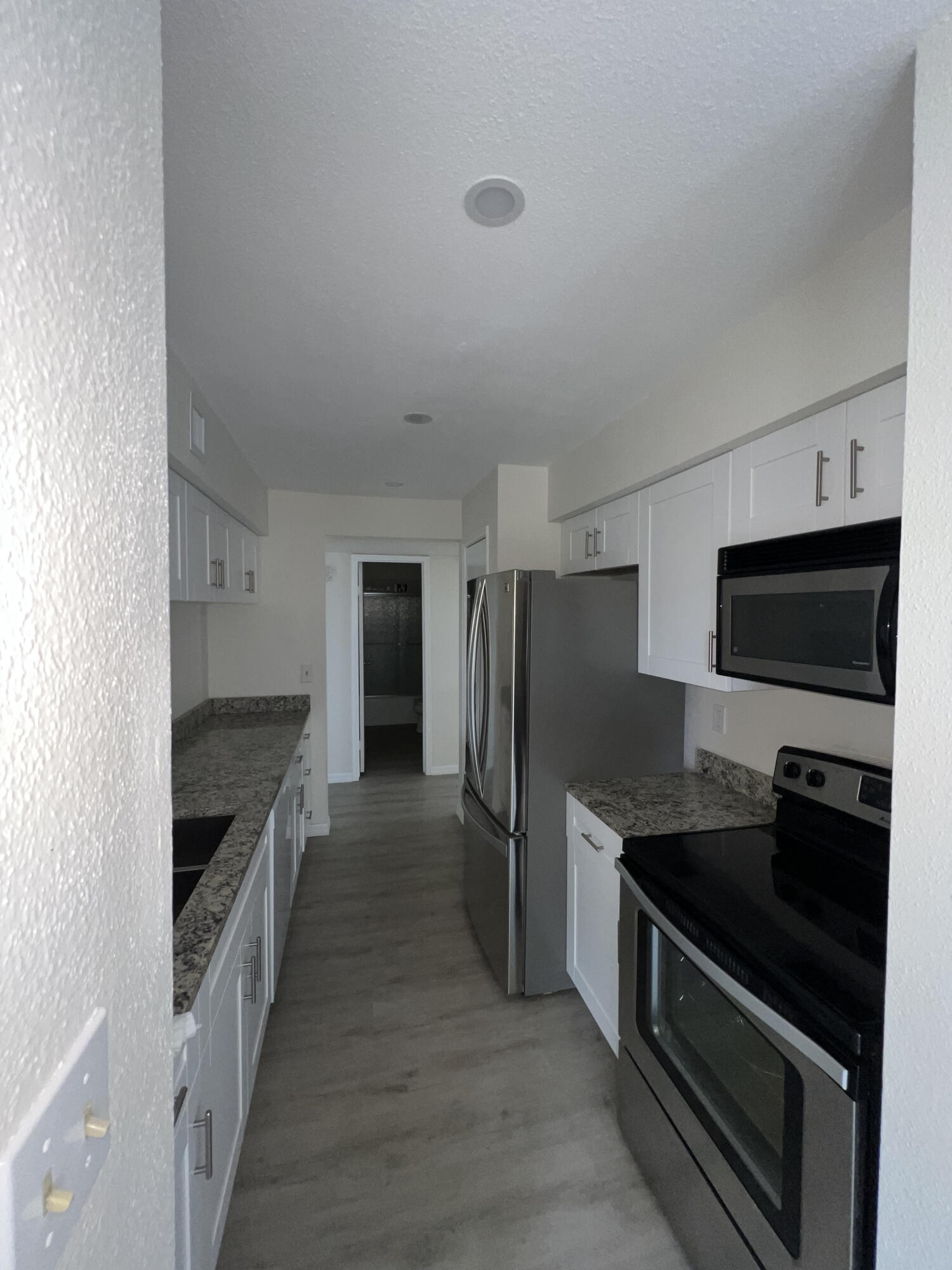 899 Riverside Drive, Unit 620 Coral Springs, FL 33071 - Photo 16 of 46 a kitchen with stainless steel appliances a stove a sink and a refrigerator