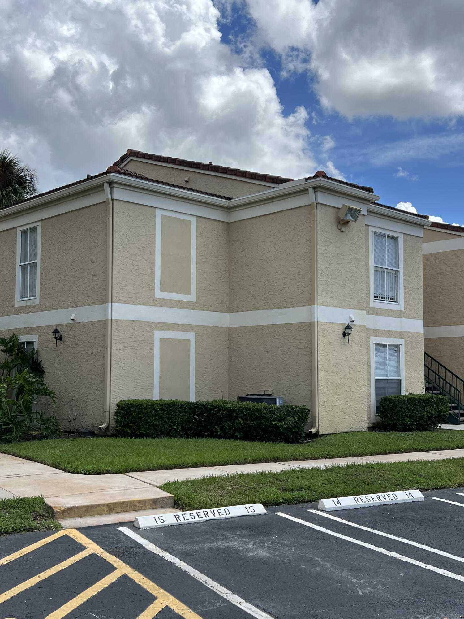 899 Riverside Drive, Unit 620 Coral Springs, FL 33071 - Photo 2 of 46 a front view of a house with a garden