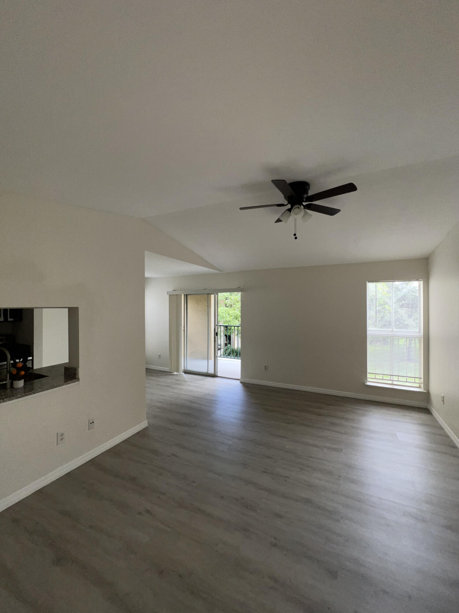 899 Riverside Drive, Unit 620 Coral Springs, FL 33071 - Photo 21 of 46 an empty room with wooden floor a ceiling fan and windows