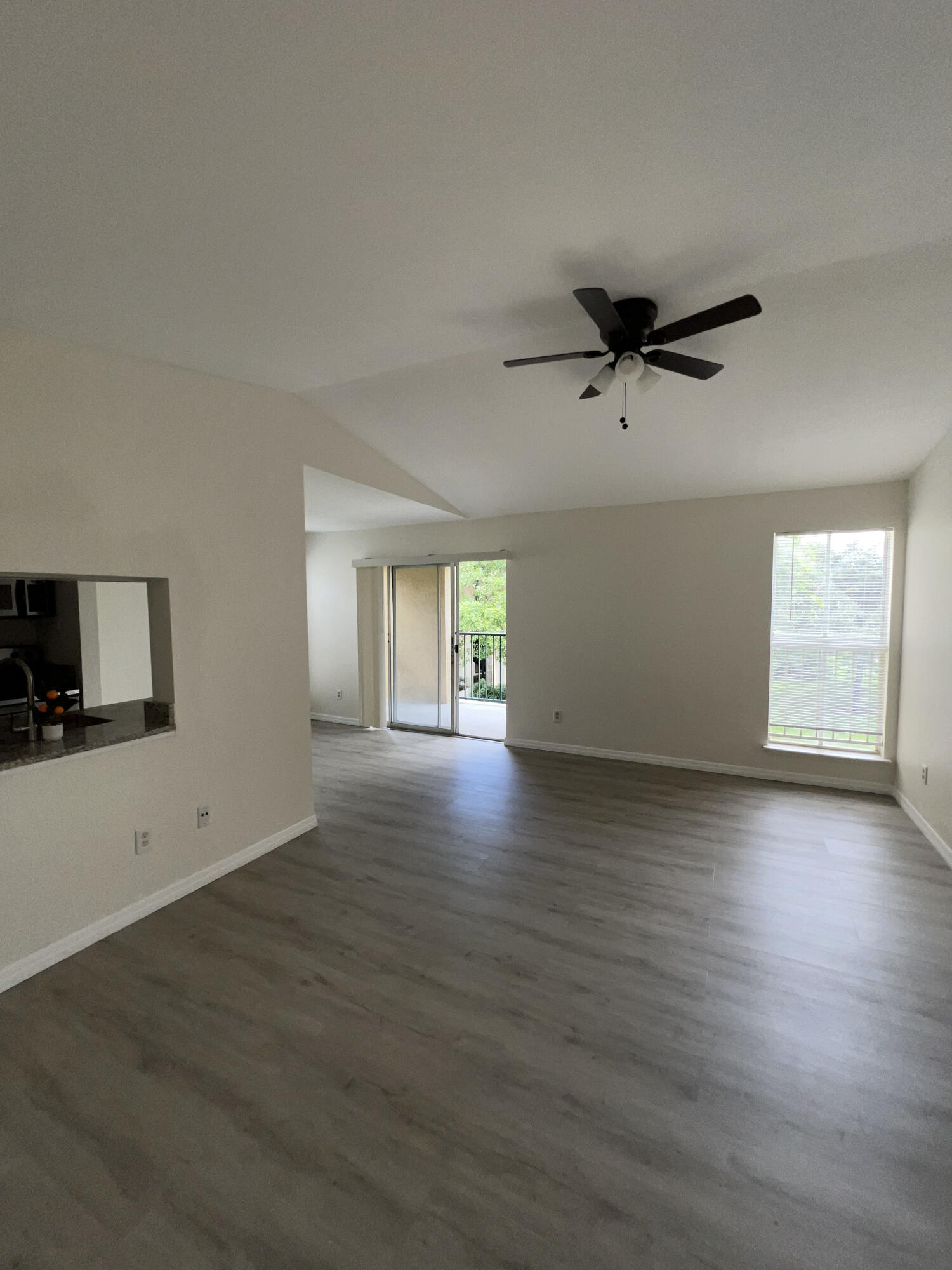 899 Riverside Drive, Unit 620 Coral Springs, FL 33071 - Photo 22 of 46 an empty room with wooden floor and windows