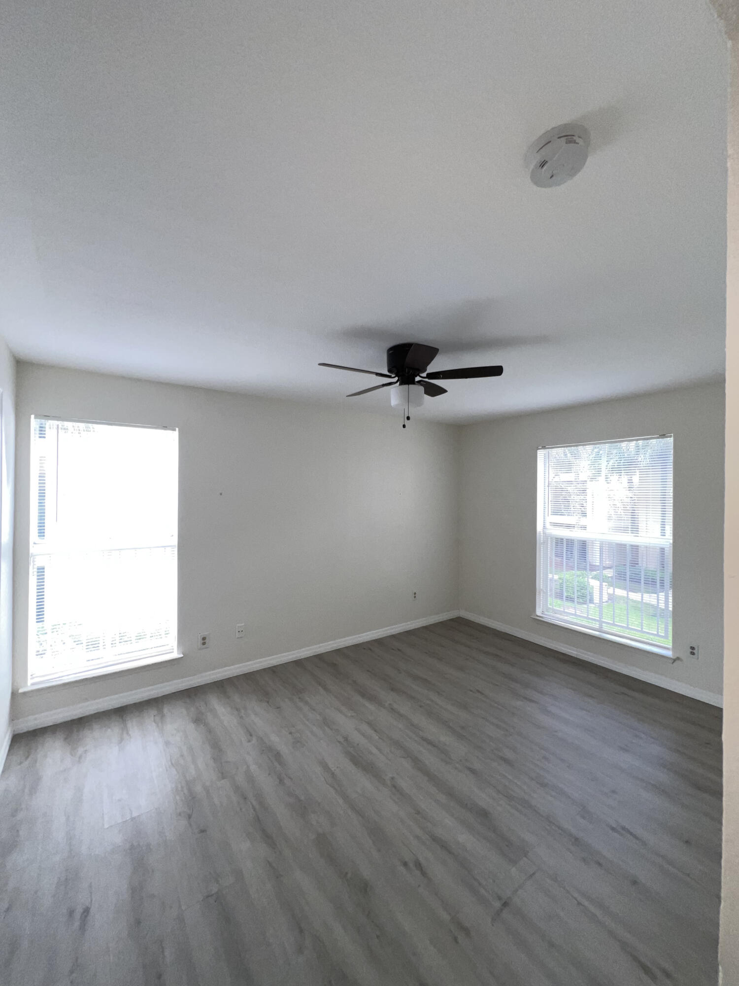 899 Riverside Drive, Unit 620 Coral Springs, FL 33071 - Photo 27 of 46 an empty room with wooden floor and windows