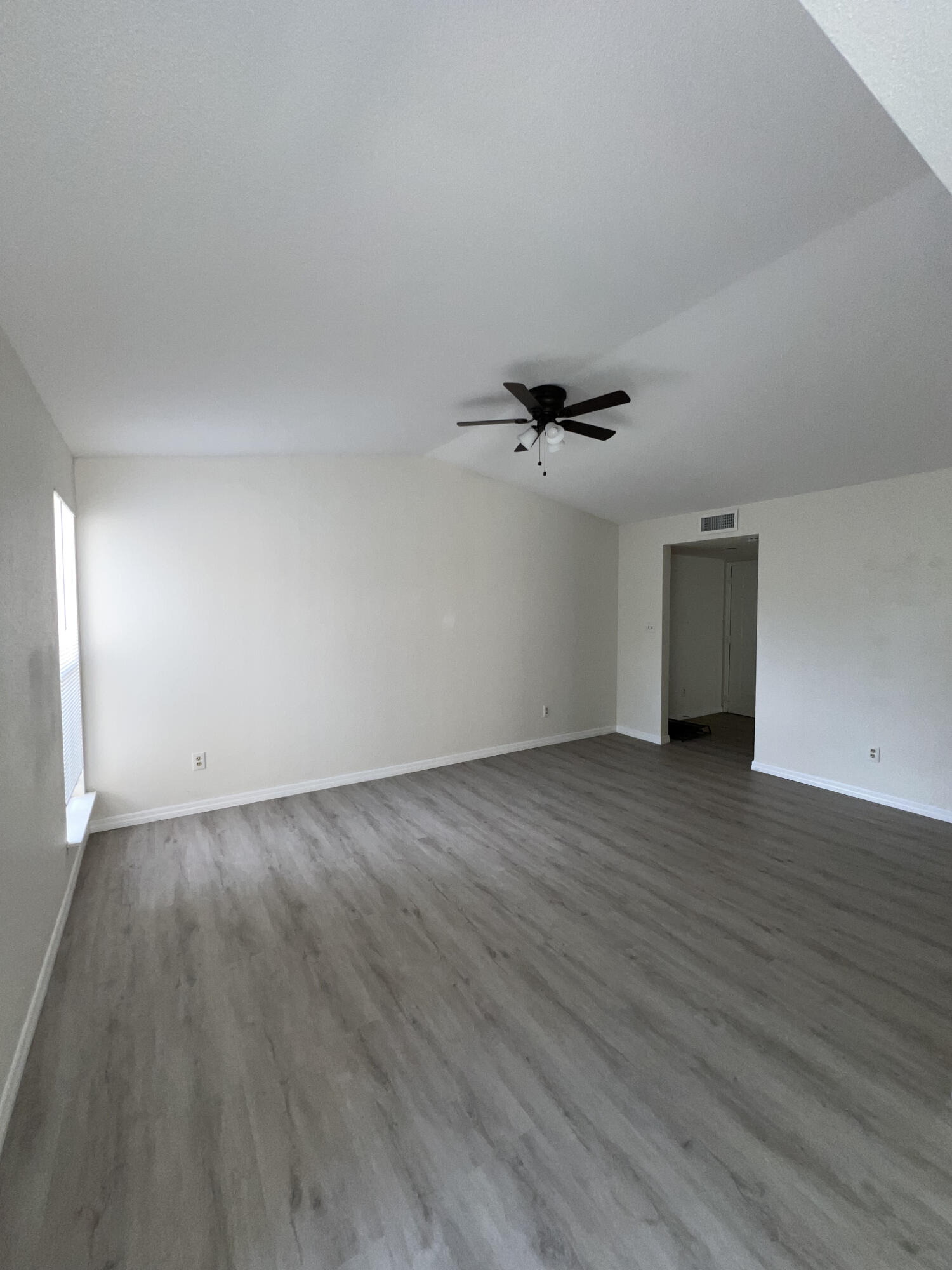 899 Riverside Drive, Unit 620 Coral Springs, FL 33071 - Photo 31 of 46 wooden floor in an empty room with a window