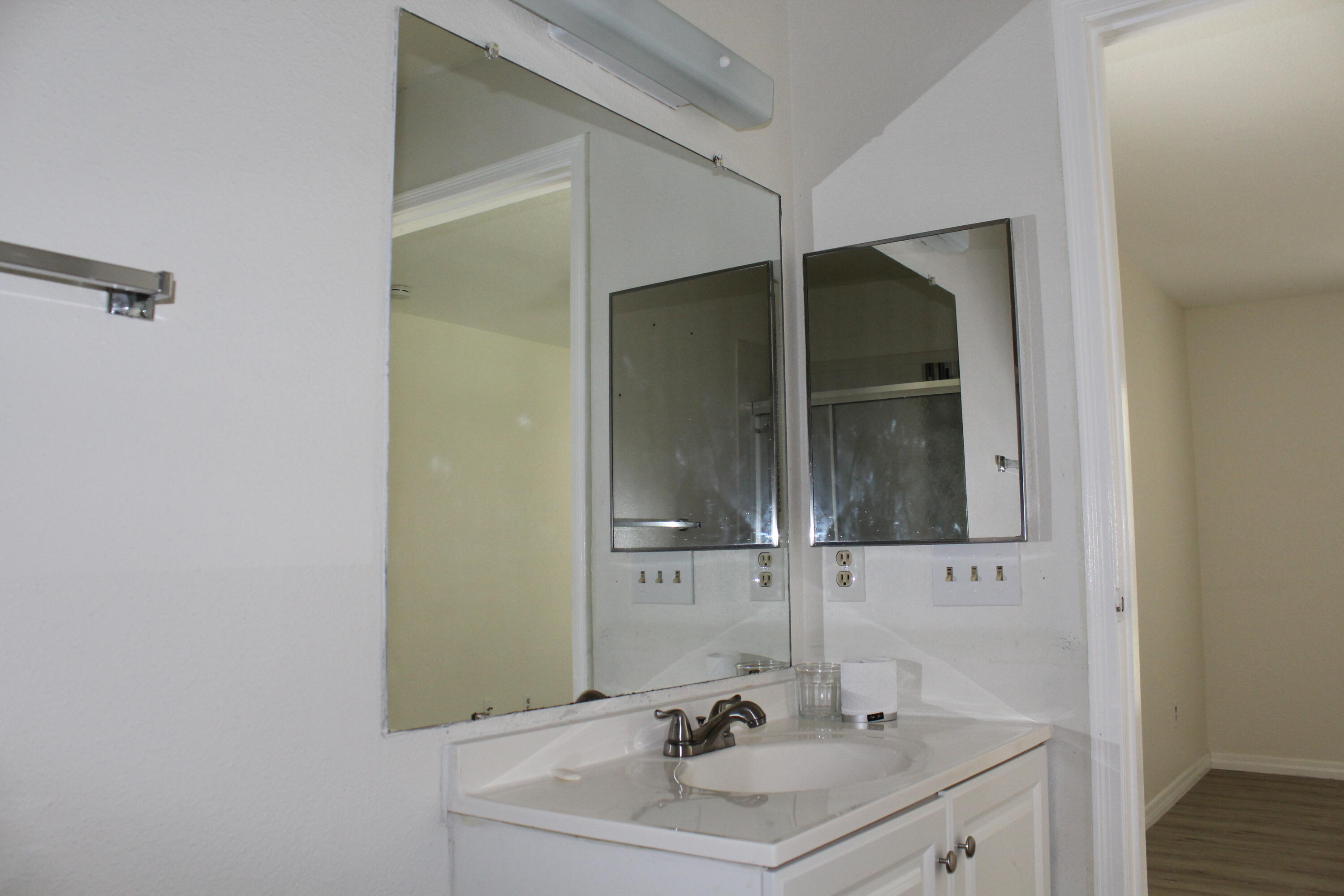 899 Riverside Drive, Unit 620 Coral Springs, FL 33071 - Photo 35 of 46 a bathroom with a sink and a mirror