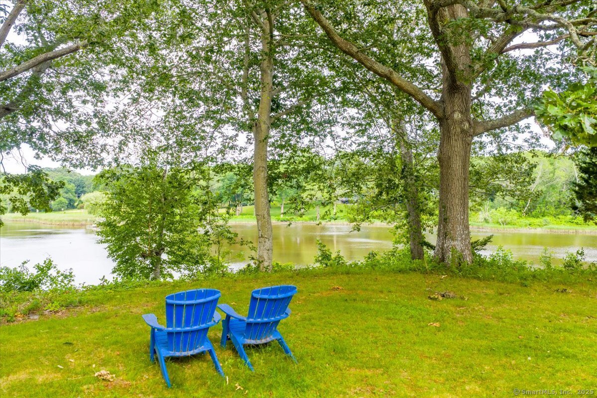 41 B River Road Essex, CT 06426 - Photo 14 of 16 a view of an chairs and table in patio next to a yard
