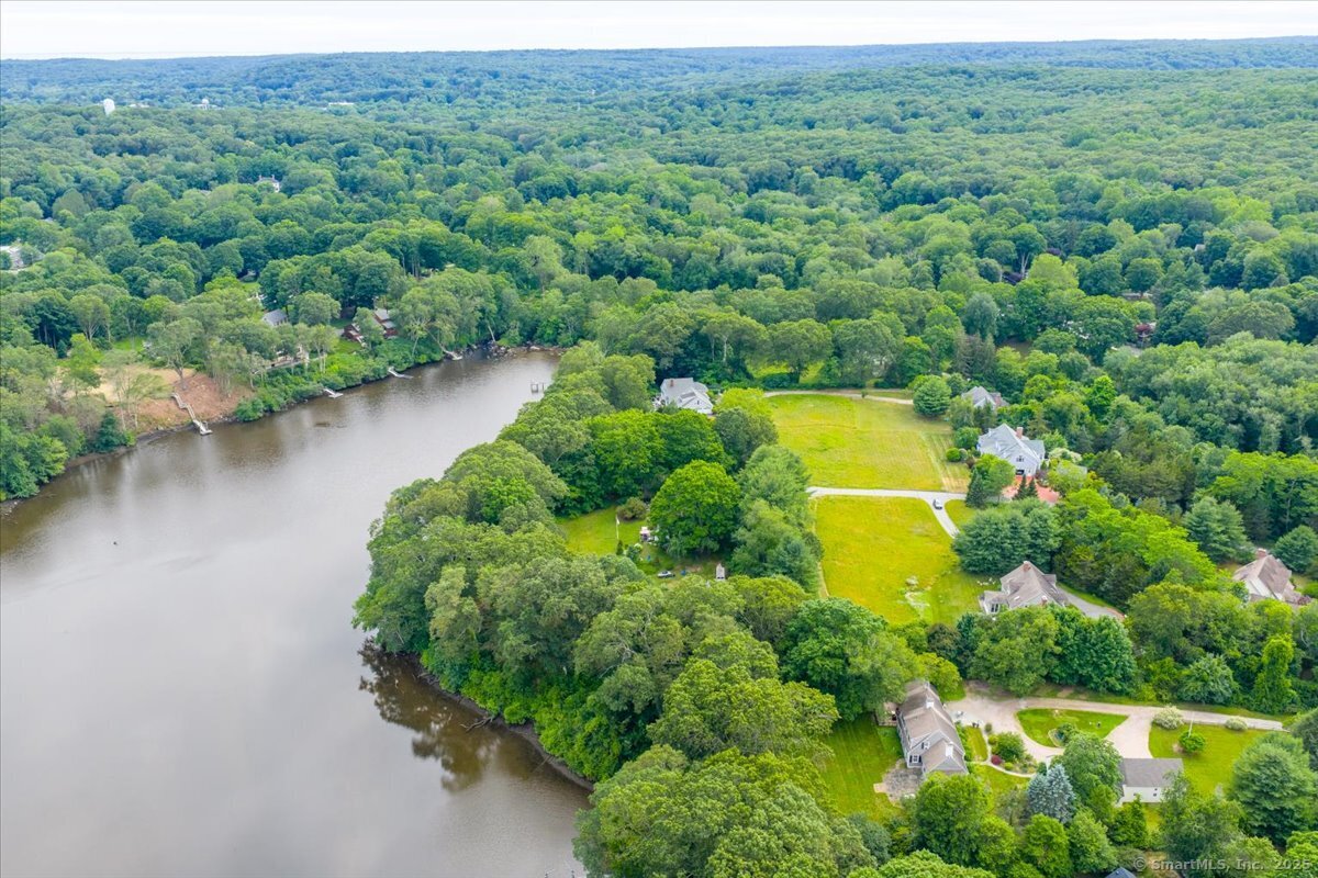 41 B River Road Essex, CT 06426 - Photo 8 of 16 a view of a forest with a houses