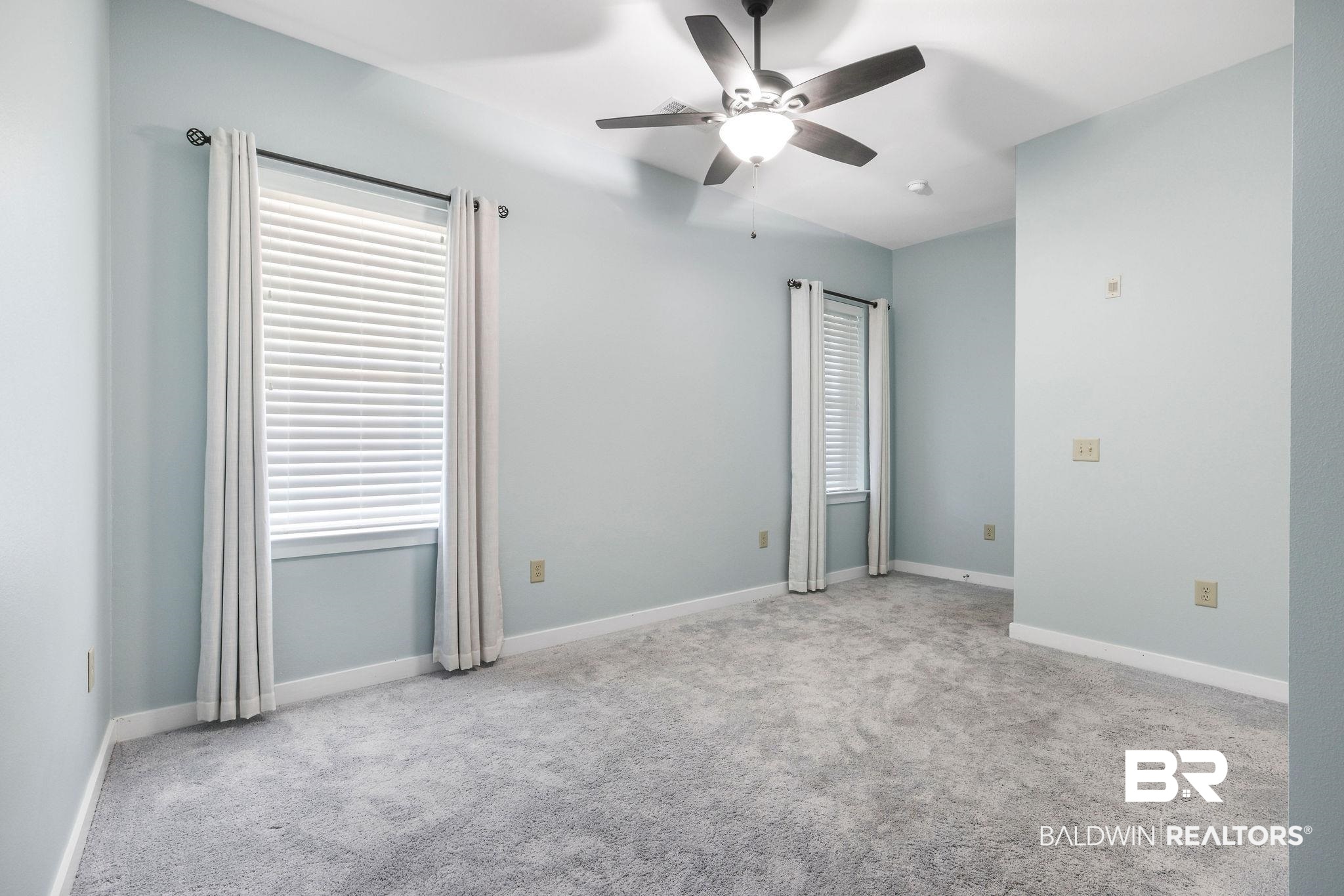 1430 Regency Road, Unit B302 Gulf Shores, AL 36542 - Photo 13 of 24 Carpeted empty room with baseboards and ceiling fan