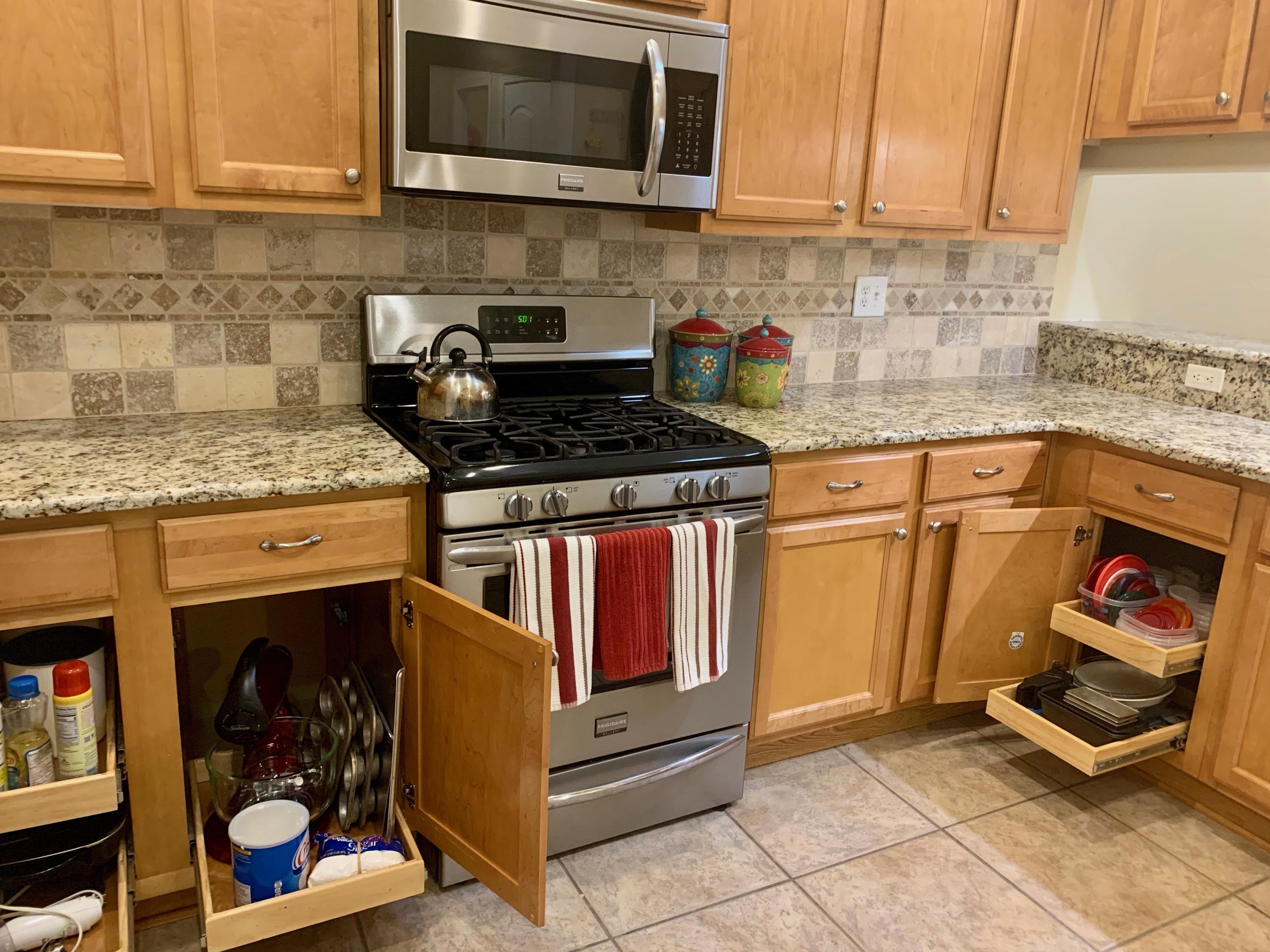 4213 Jade Loop Destin, FL 32541 - Photo 11 of 46 a kitchen with stainless steel appliances granite countertop a stove and a microwave