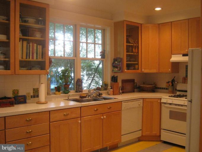 4706 Keswick Road Baltimore, MD 21210 - Photo 14 of 22 a kitchen with a sink stove and cabinets