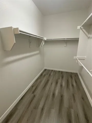 a view of a room with wooden floor