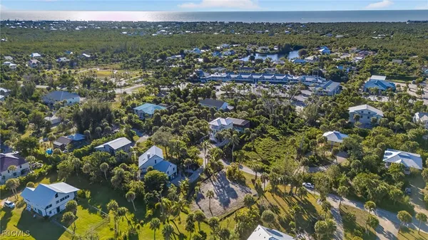 an aerial view of residential houses with city view