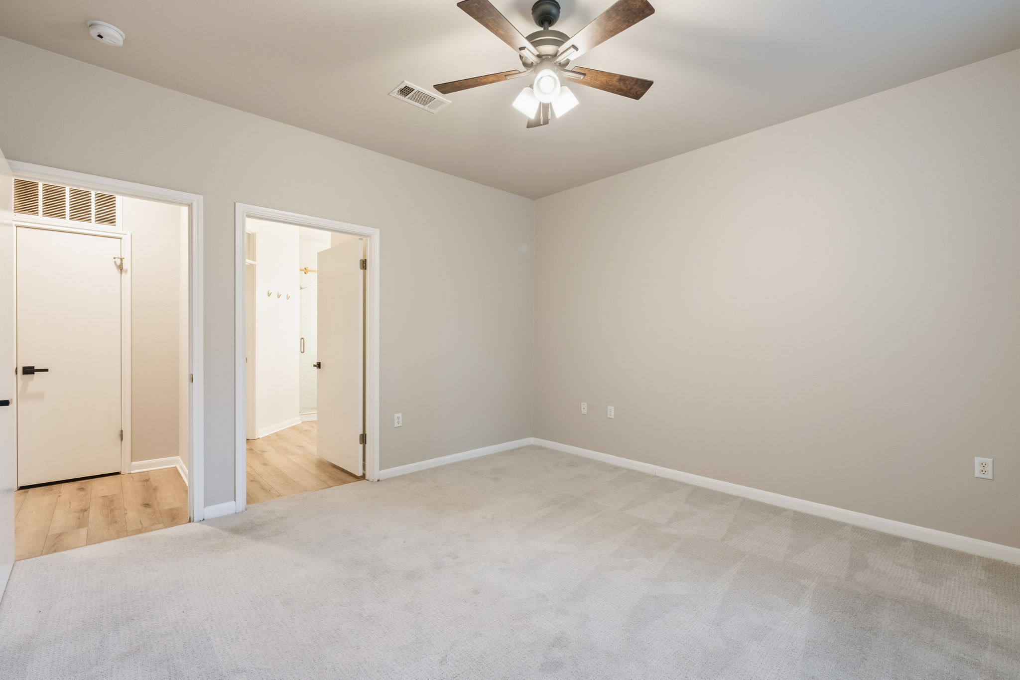 137 Trail Rider Way Georgetown, TX 78633 - Photo 11 of 29 A spacious and uncluttered sleeping area with light-colored walls and plush carpeting awaits.